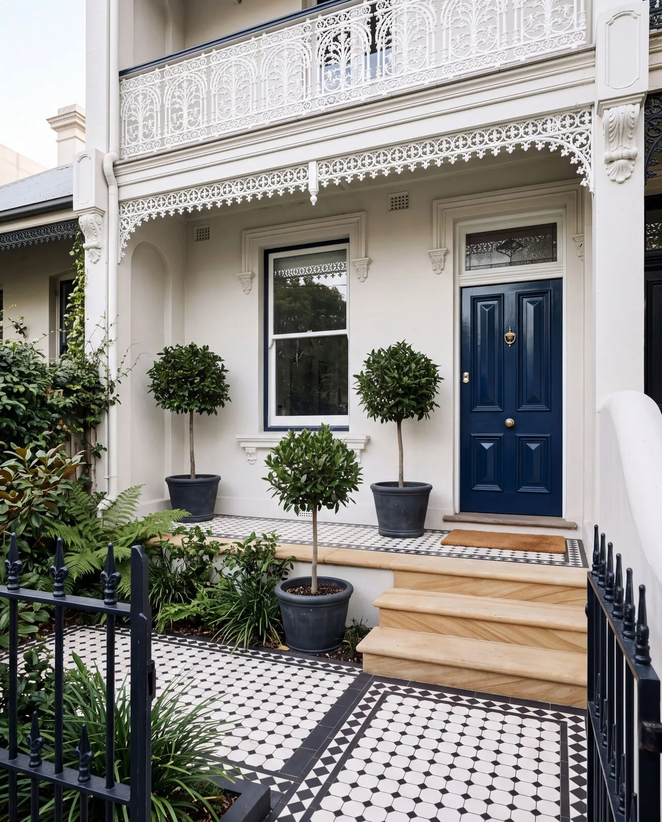 Terrace house entry with clean sandstone steps and tiled path