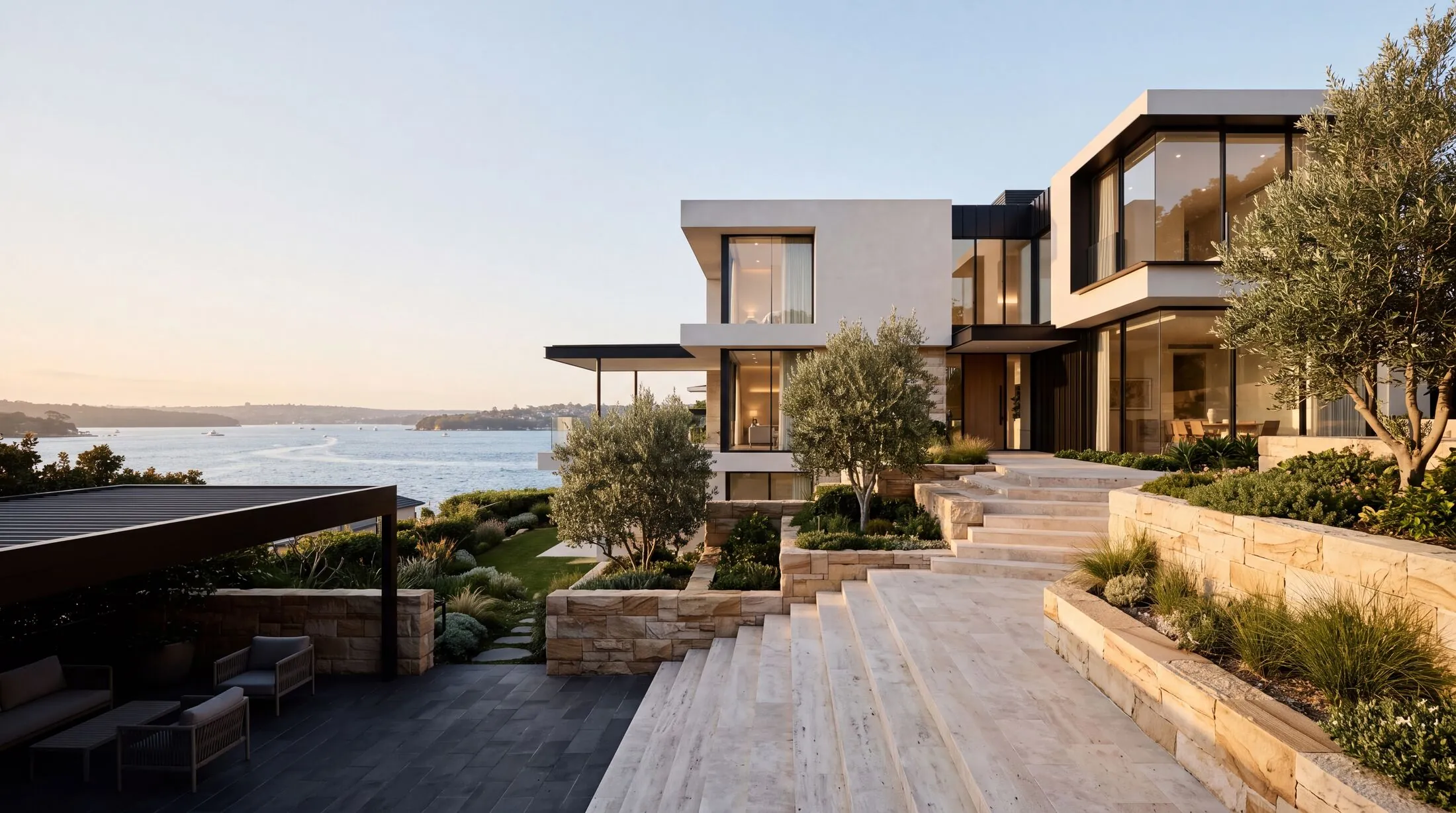 Harbourside Vaucluse home with clean white render, sandstone walls and travertine steps